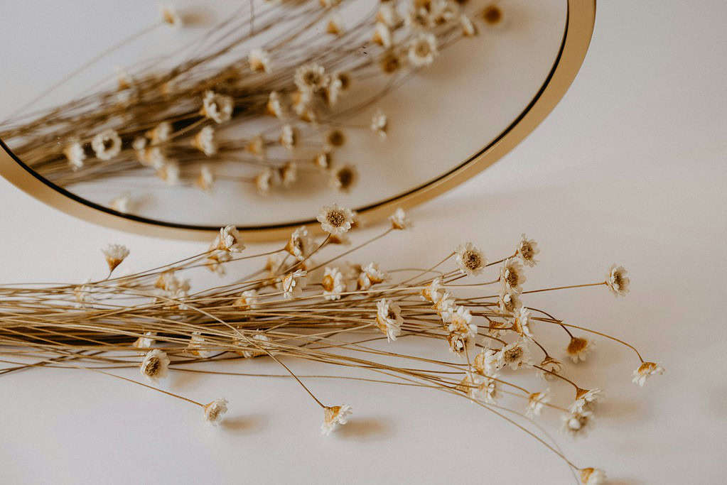 Mirror reflecting flowers