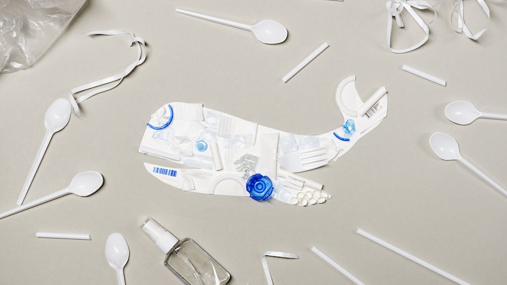Plastic Products and a Whale Cutout on a Gray Surface